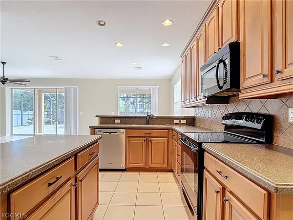 a kitchen with stainless steel appliances granite countertop a sink and stove top oven