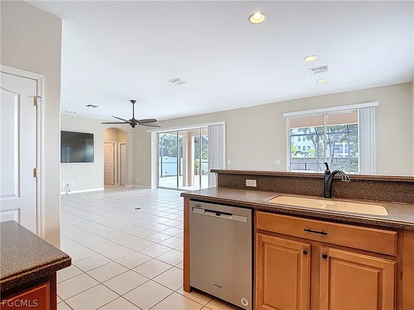 a kitchen with granite countertop a sink and white cabinets