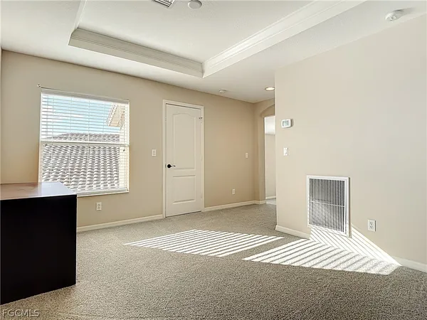 a view of empty room with windows and wardrobe