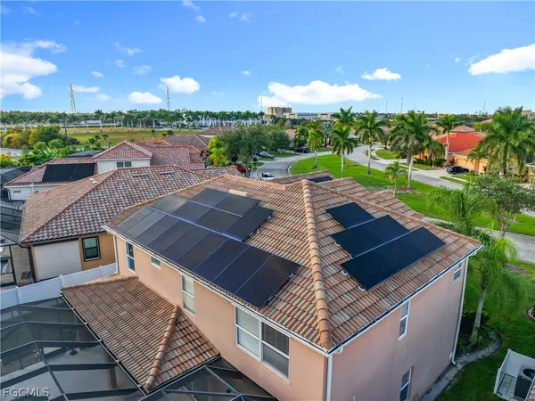 an aerial view of a house with a garden and outdoor seating