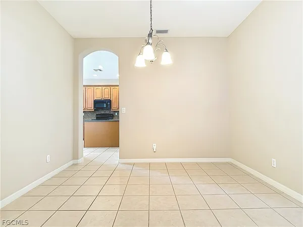 a view of a kitchen with wooden floor and a chandelier