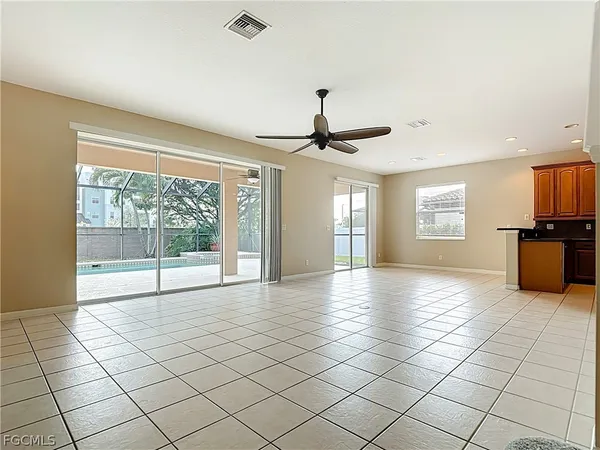 a view of a livingroom with a ceiling fan and window