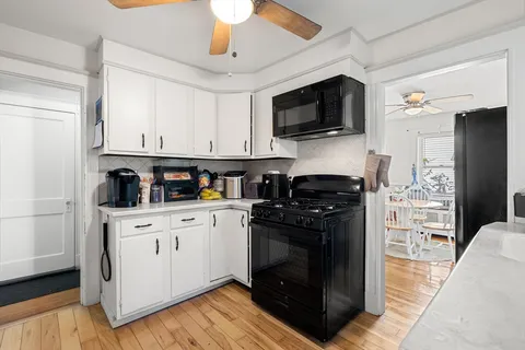 a kitchen with stainless steel appliances a stove a microwave and a refrigerator
