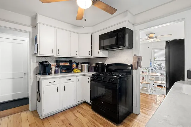 a kitchen with stainless steel appliances a stove a microwave and a refrigerator