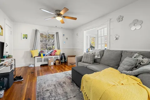 a living room filled with furniture and a large window