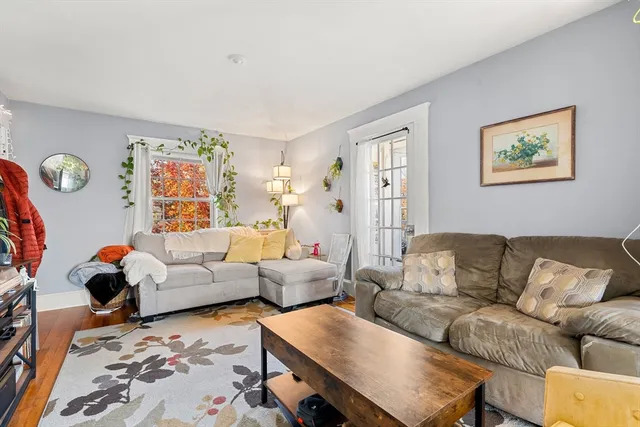 a living room with furniture fireplace and a window