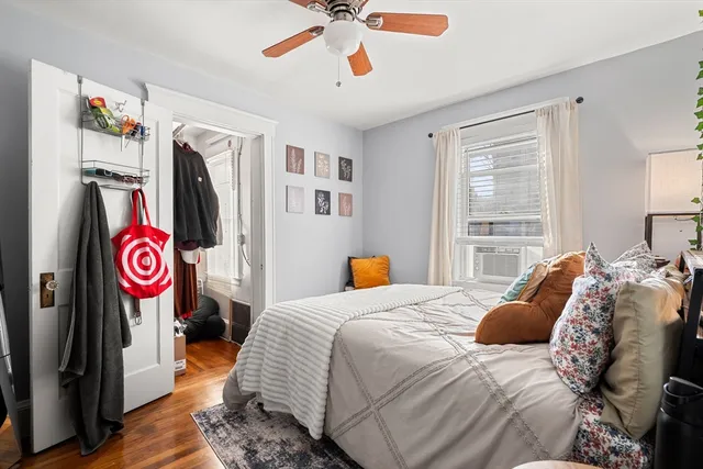a bedroom with a bed and a flat tv screen
