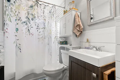 a view of a house with a table and chair under an umbrella