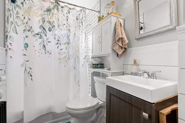 a view of a house with a table and chair under an umbrella