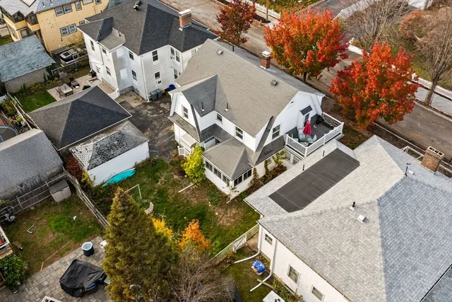 an aerial view of a house with a yard
