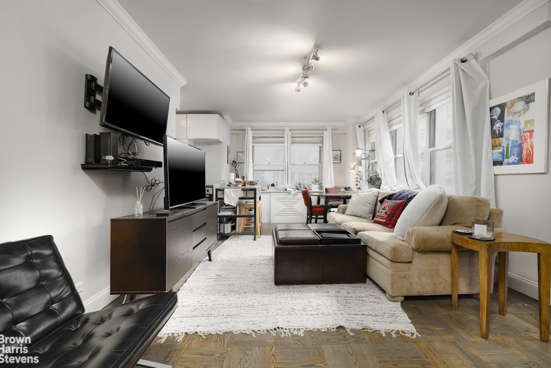 166 East 35th Street, Unit 7A Manhattan, NY 10016 - Photo 1 of 15 a living room with furniture and a flat screen tv