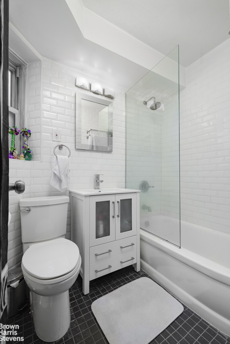 166 East 35th Street, Unit 7A Manhattan, NY 10016 - Photo 13 of 15 a bathroom with a toilet a sink and shower