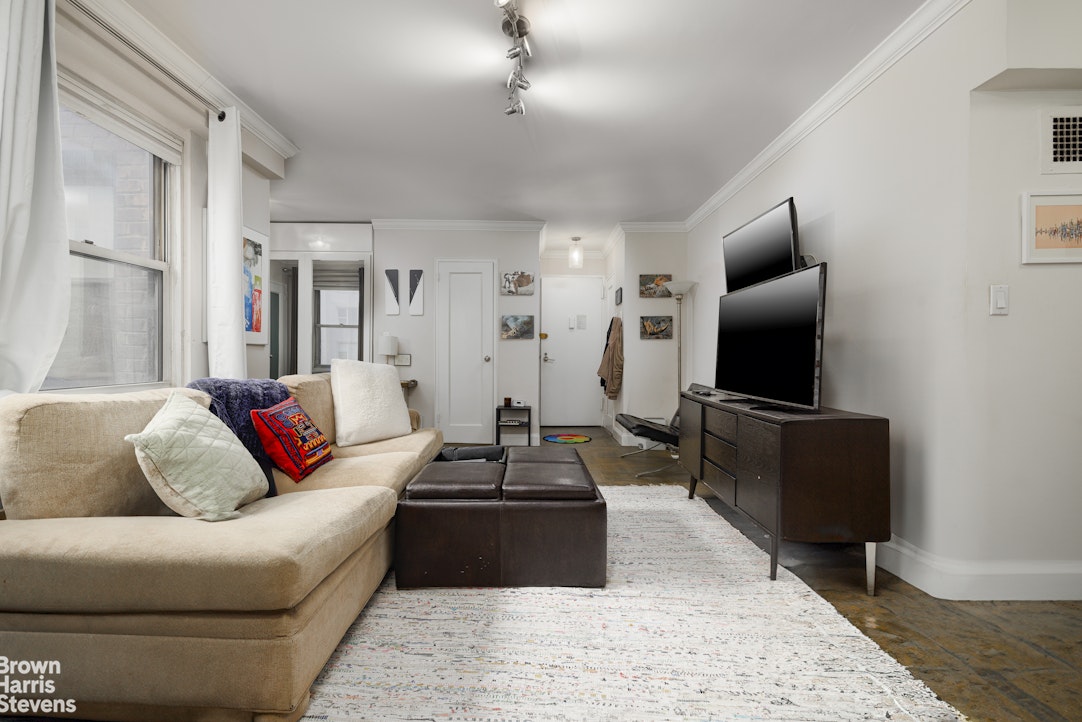 166 East 35th Street, Unit 7A Manhattan, NY 10016 - Photo 3 of 15 a living room with furniture and a flat screen tv
