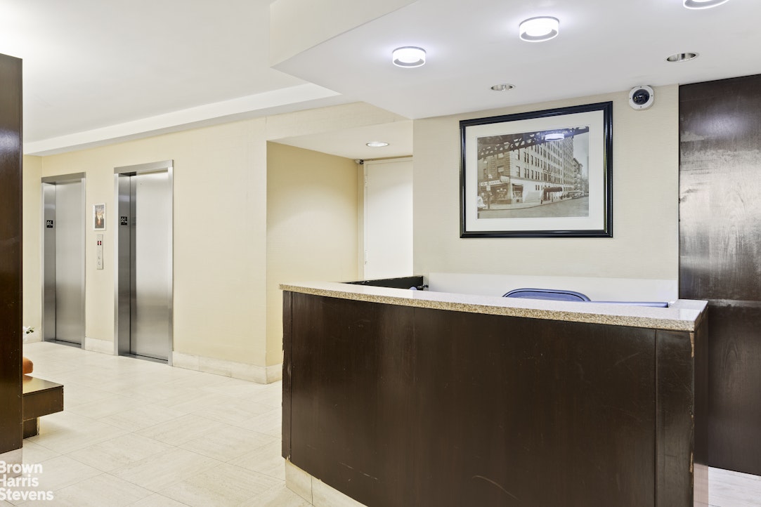 166 East 35th Street, Unit 7A Manhattan, NY 10016 - Photo 8 of 15 a view of workspace with stainless steel appliances wooden floor