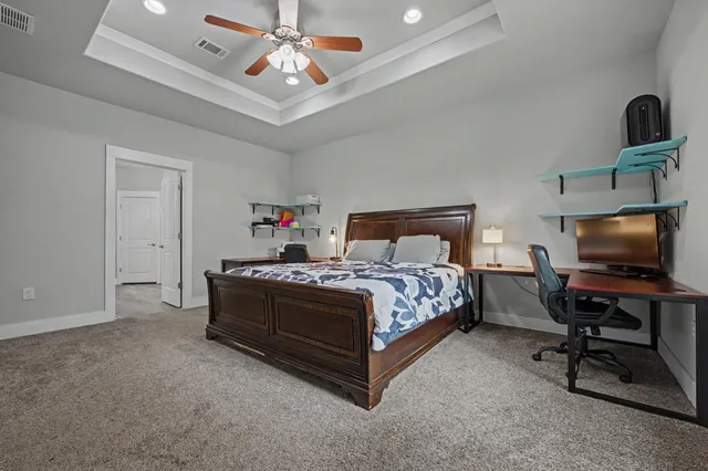 a spacious bedroom with a bed and a desk