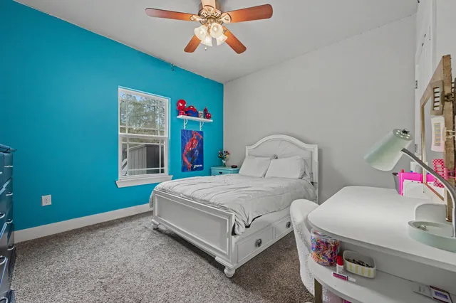 a bedroom with bed and a chandelier