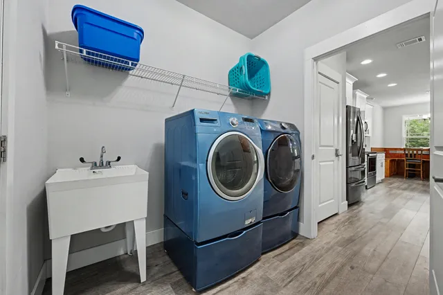 a utility room with sink dryer and washer