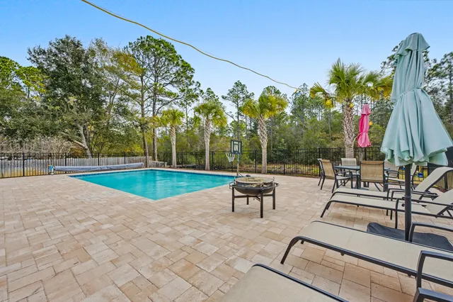 swimming pool with outdoor seating and garden