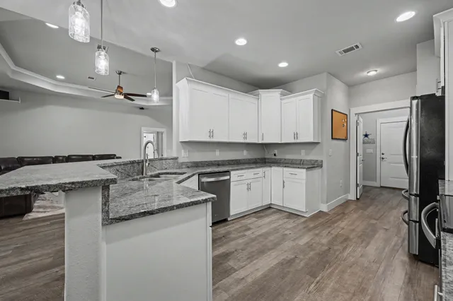 a kitchen with a sink stove and refrigerator