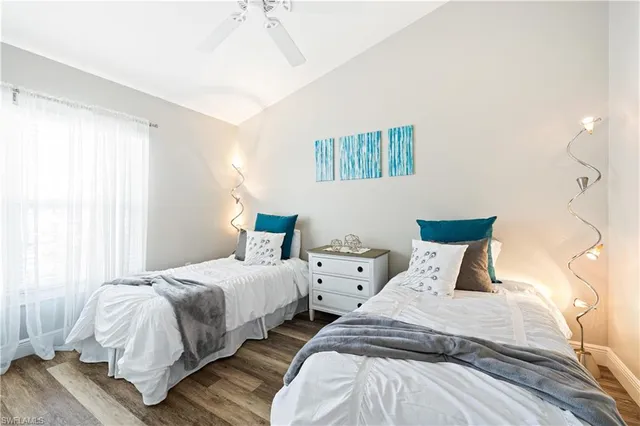 a bedroom with two beds and a window