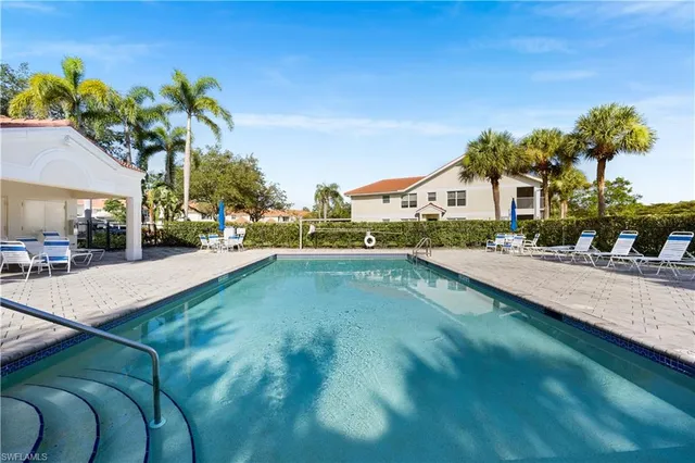 a swimming pool with outdoor seating and yard