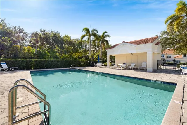 a view of swimming pool with a garden and trees