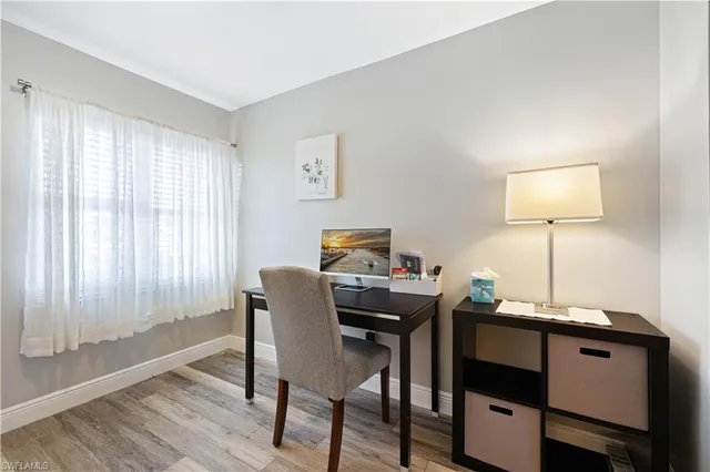 a view of a workspace with furniture and wooden floor