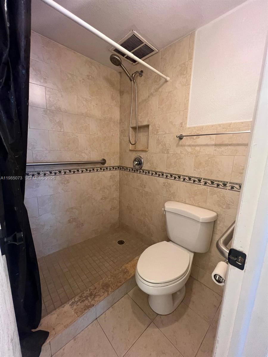 1900 West 68th Street, Unit D207 Hialeah, FL 33014 - Photo 25 of 33 a bathroom with a toilet and a shower