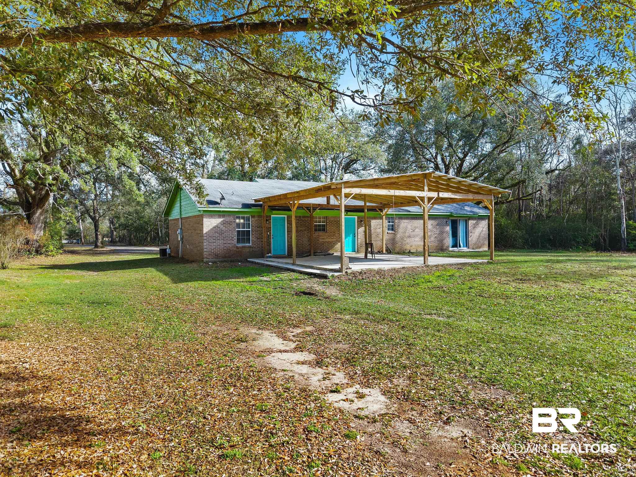17366 Old Brady Road Bay Minette, AL 36507 - Photo 39 of 43 Rear view of house with a lawn, a patio area, and brick siding
