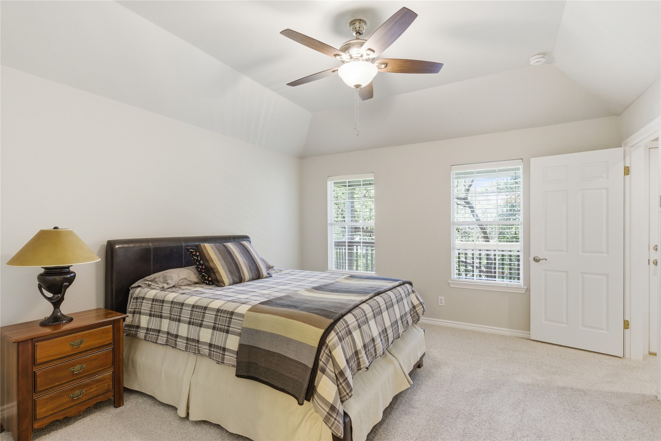 1204 Orlando Road Austin, TX 78733 - Photo 9 of 40 Relax in this tranquil bedroom, featuring a vaulted ceiling and ample natural light.