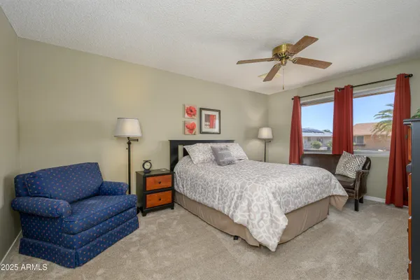 a bedroom with a bed couch and window
