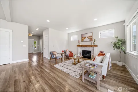 a living room with furniture fireplace and window