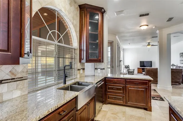 a kitchen with a sink stove and cabinets