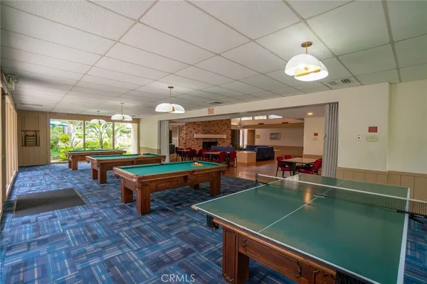 a room with pool table and windows