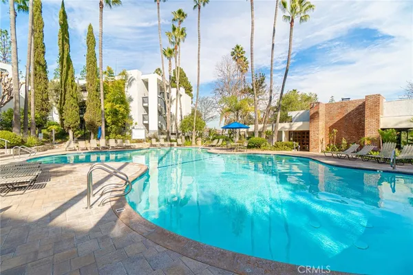 a view of a swimming pool with a yard