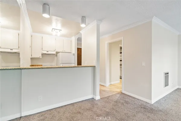 a view of a kitchen with a sink and a cabinet