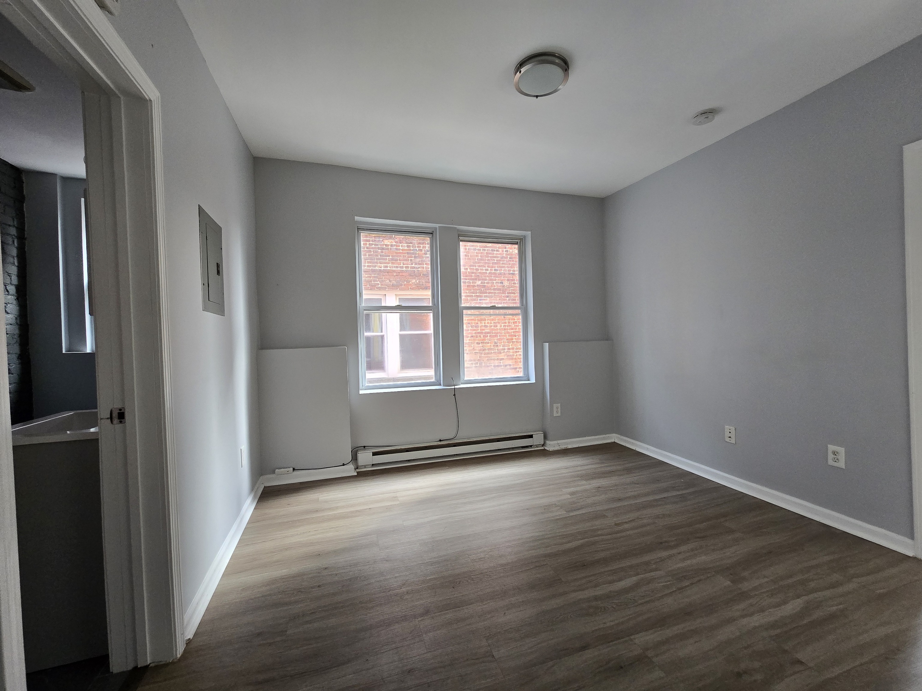 31 Whittier Street, Unit 3B Bridgeport, CT 06605 - Photo 2 of 5 an empty room with wooden floor and windows