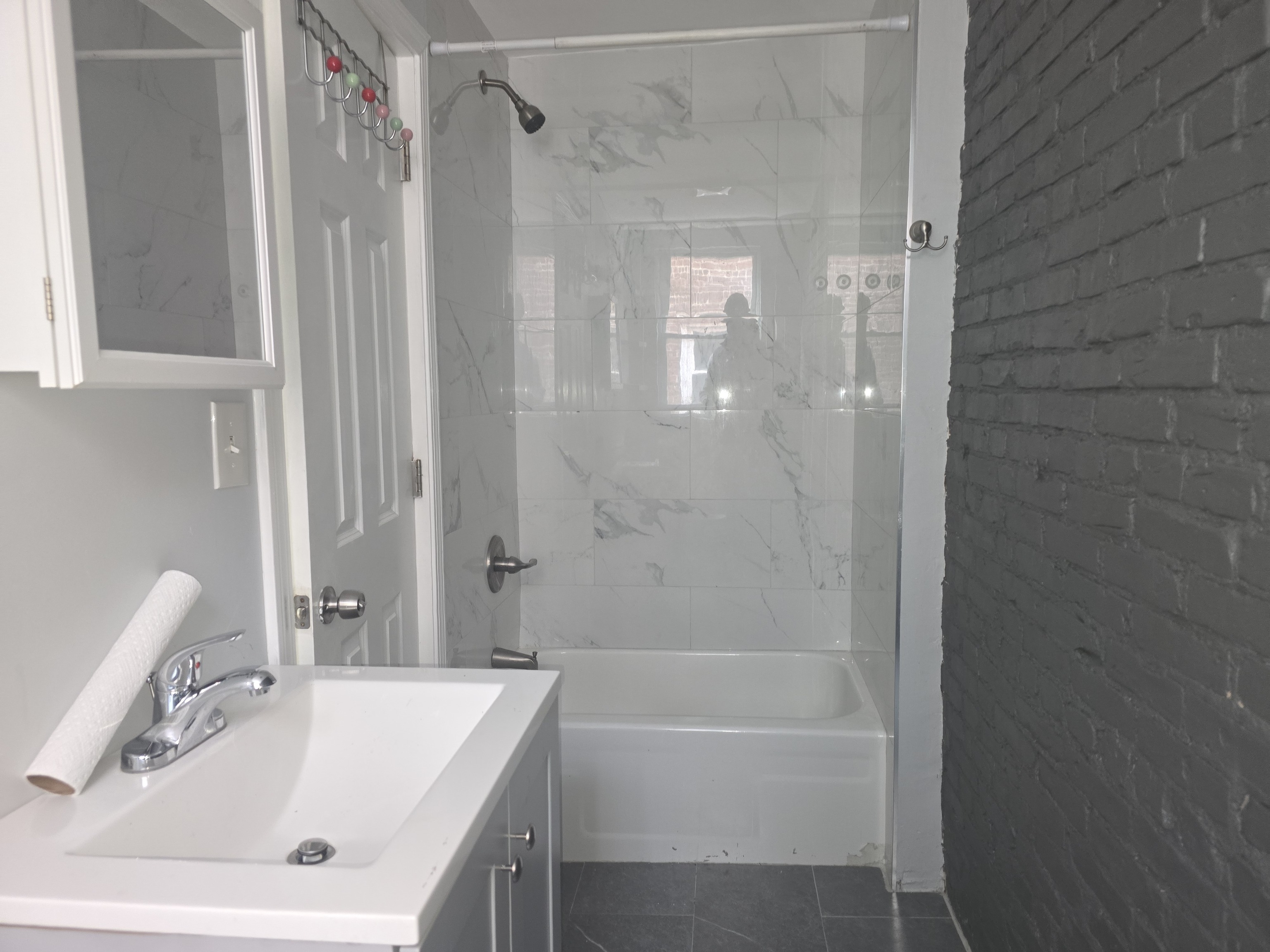 31 Whittier Street, Unit 3B Bridgeport, CT 06605 - Photo 3 of 5 a bathroom with a tub a sink and a shower