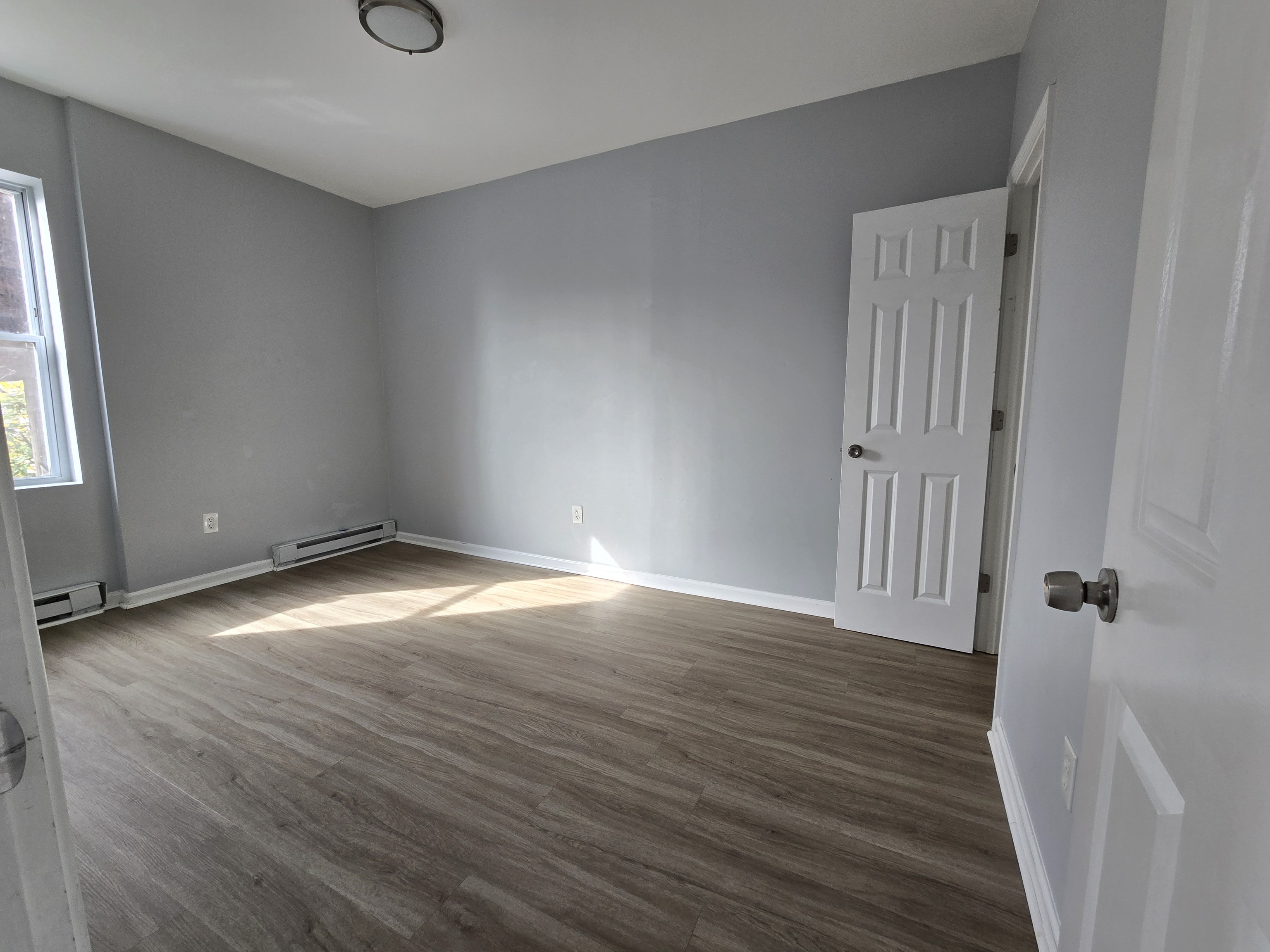 31 Whittier Street, Unit 3B Bridgeport, CT 06605 - Photo 4 of 5 an empty room with wooden floor and a window