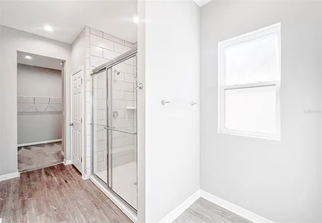 a view of hallway with wooden floor