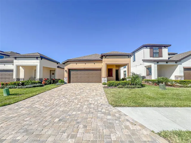 a front view of a house with a yard and garage