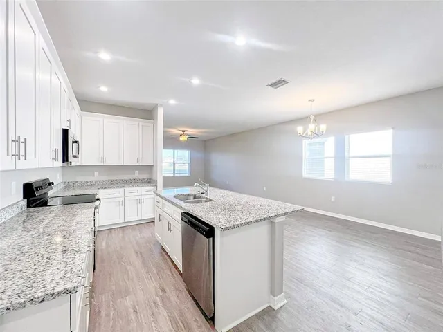 a kitchen with a stove a sink and a refrigerator