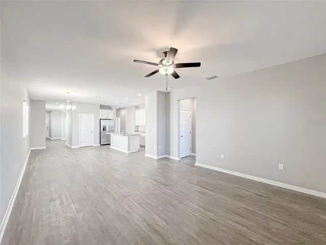 a view of an empty room with a ceiling fan