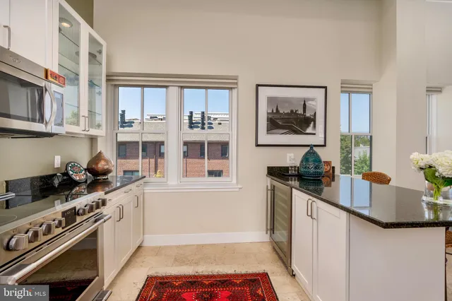 a kitchen with stainless steel appliances a stove a sink and a refrigerator