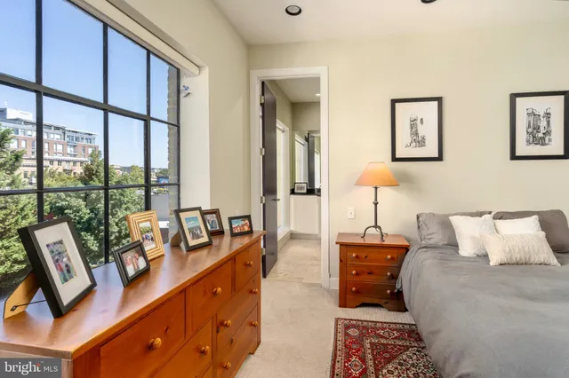 a bedroom with furniture and a large window
