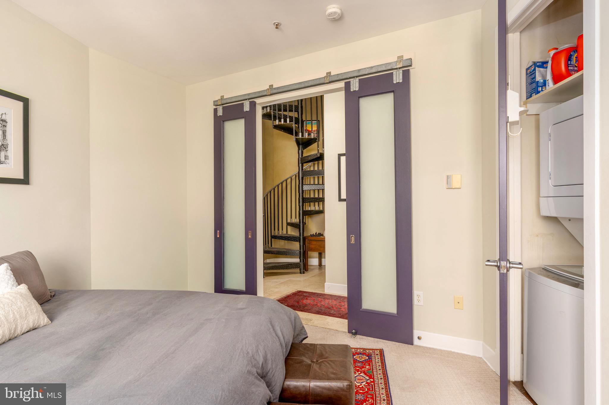 1741 Johnson Avenue Northwest, Unit 301 Washington, DC 20009 - Photo 17 of 31 a bedroom with a bed and a walk in closet