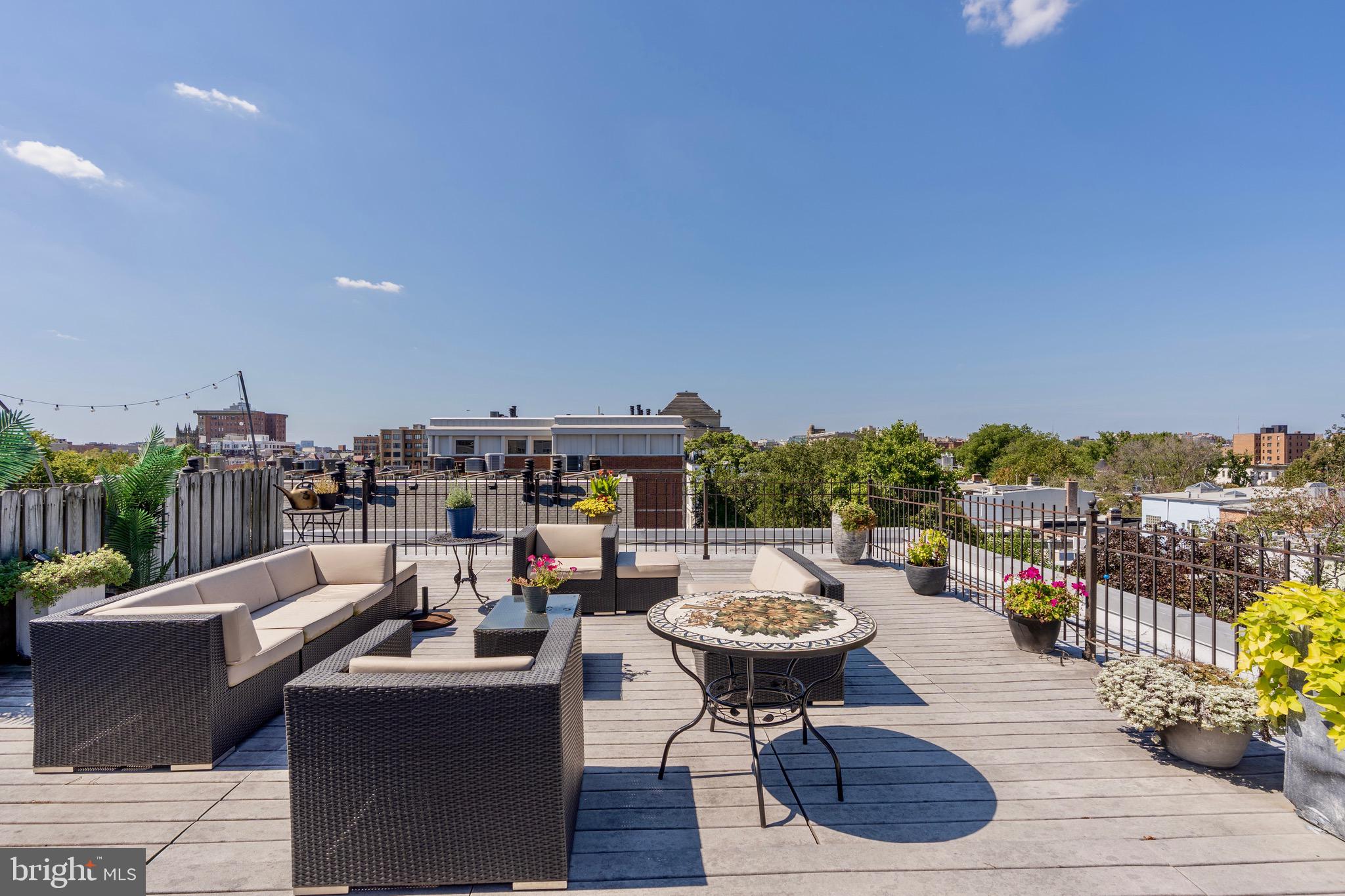 1741 Johnson Avenue Northwest, Unit 301 Washington, DC 20009 - Photo 22 of 31 a view of a terrace with furniture and a potted plant