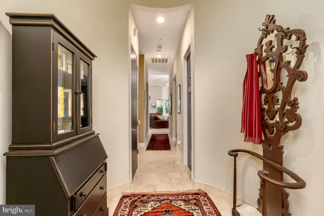 a view of a hallway with entryway and furniture