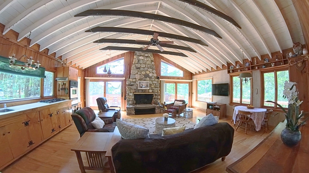 32 Pond Hill Road Goshen, MA 01096 - Photo 6 of 24 a living room with furniture fireplace and large windows