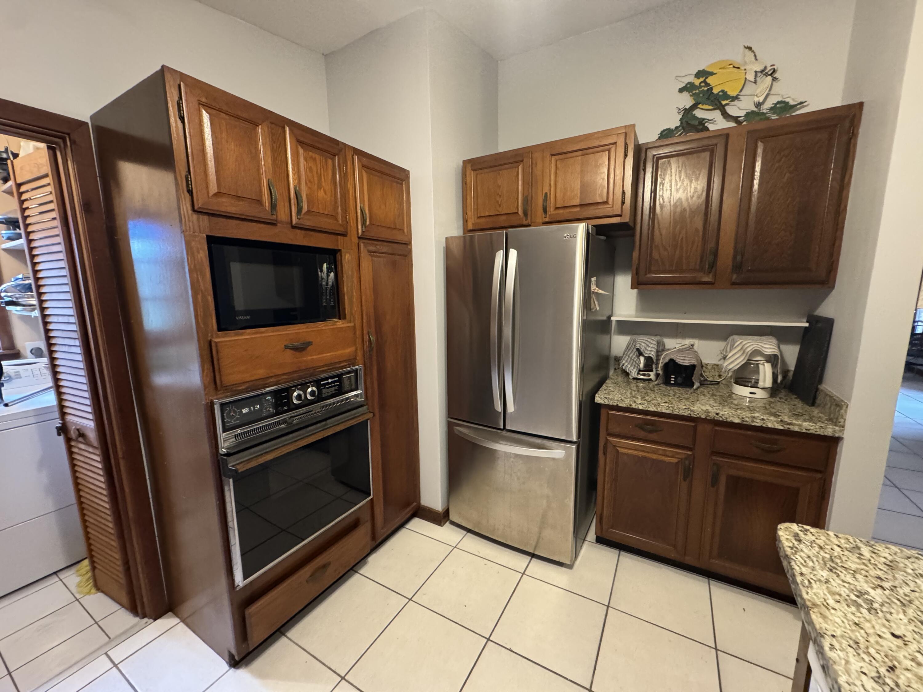 22970 Sharp Lane Cudjoe, FL 33042 - Photo 12 of 45 a kitchen with granite countertop stainless steel appliances and wooden cabinets